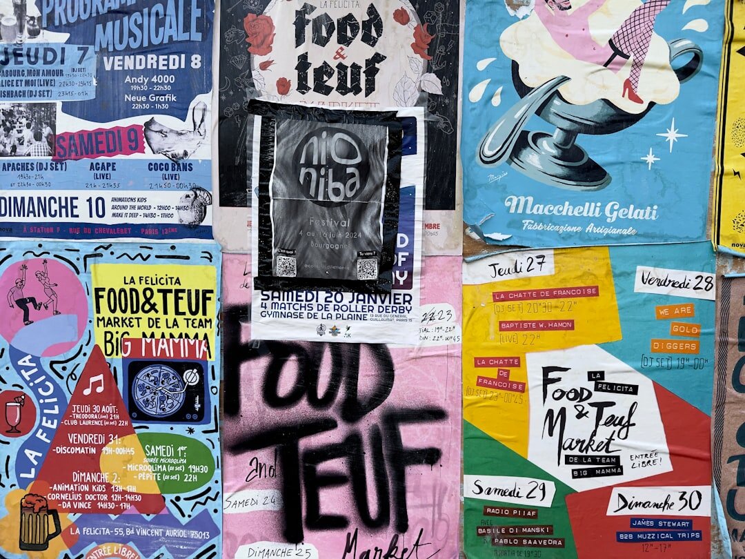 Wall covered with colourful vintage advertising posters and print ads